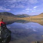 Person looking over Lough Feeagh, Nephin Beg Mountains, Co Mayo, Ireland.